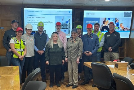 A group of employees and visitors posing for a photo at Ardagh's Burlington facility